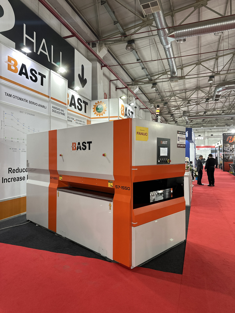 BAST industrial machine exhibited at a trade show booth